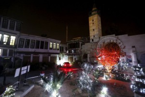 Christmas holiday lights hang from trees in the ancient quarter of Bab-Sharqi in Damascus